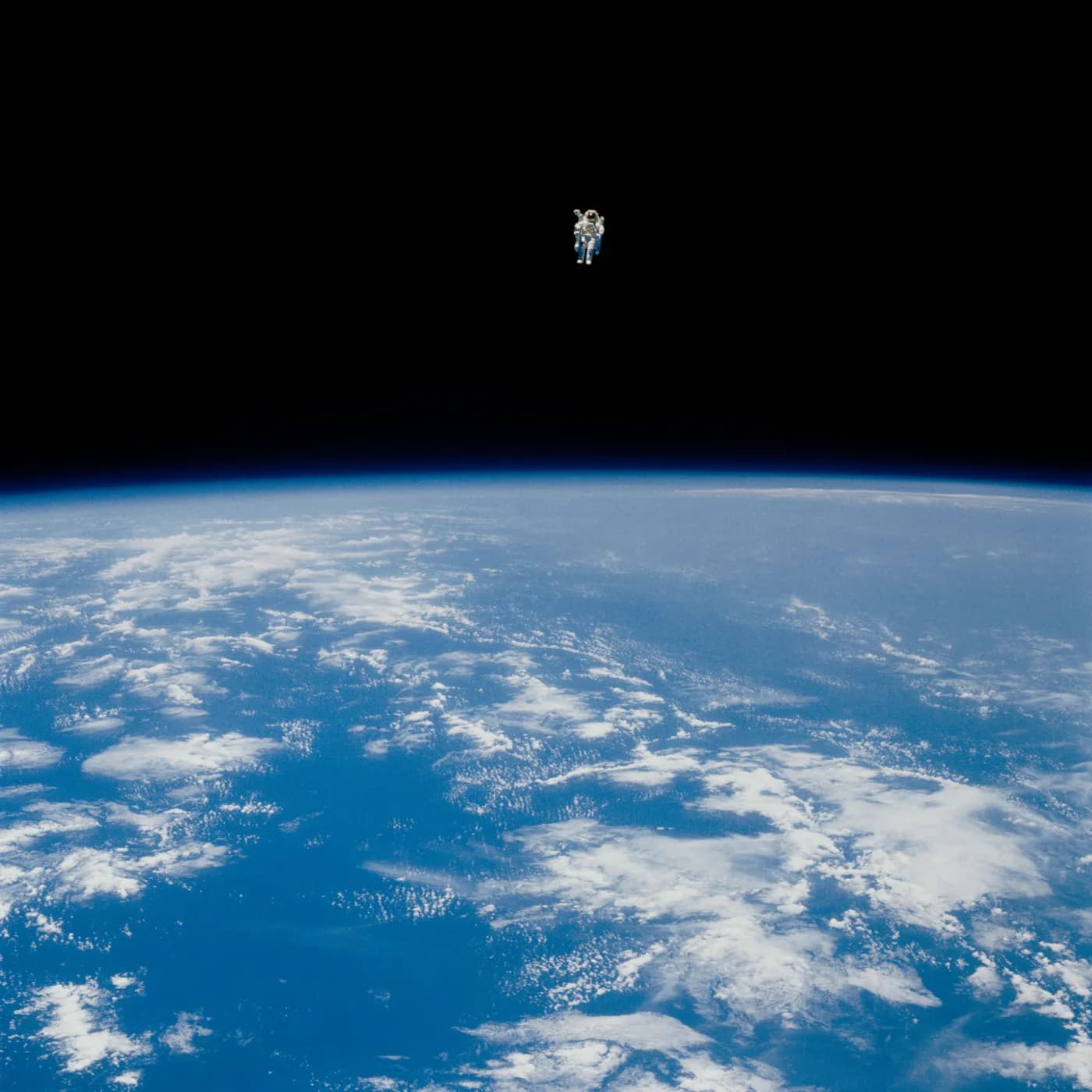 An astronaut on an untethered spacewalk above Earth