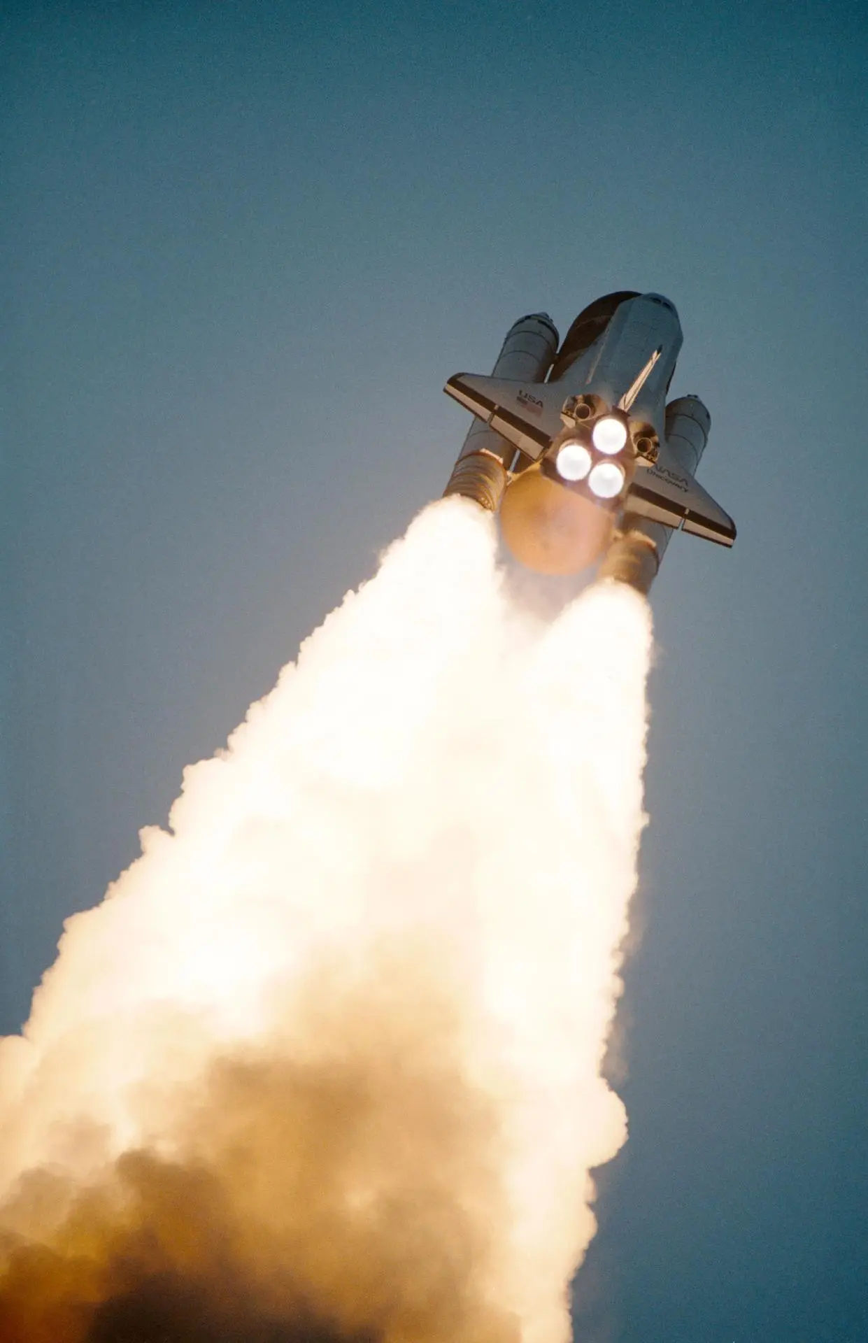 A shuttle stack climbing away from the pad on ascent